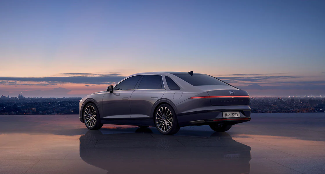 The image of The all-new AZERA on the highway under sunset.